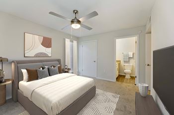 A bedroom with a large bed and a ceiling fan.